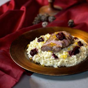 Duck fillet with wild fruits, parmesan risotto, orange and white chocolate